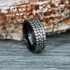 a black and silver ring with an old tire pattern