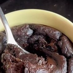 a bowl filled with brownie pudding and a spoon