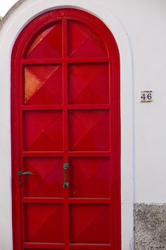 a red door with an arched window on the outside