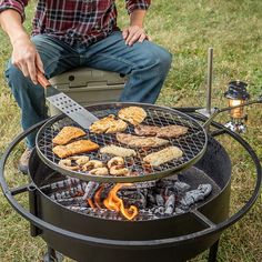 a man is cooking chicken on an outdoor grill