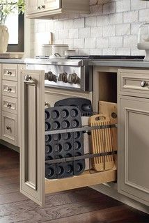 an open cabinet in the middle of a kitchen