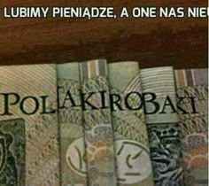 there are many different bank notes on the shelf in front of each other, including one that says polakrobat