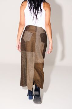 A classic straight-fit midi skirt in patchwork perfection, a Fall must-have. FEATURES: Patch-worked exterior. Clean finished single-stitch waistband, classic patch pockets at back and curved denim inspired pockets at front. Elongated vent at center back for ease of wear. MAKING: Made in Lima, Peru by master tailor Nore Encizo and his team. CONTENT: 100% Upcycled Merino Wool. FIT: Sits at Waist. Midi/ Ankle length. MODEL IS WEARING A SIZE 8. MADE TO ORDER SIZES SHIP 4 WEEKS FROM ORDER DATE. Fitted Midi Skirt, Master Tailor, Upcycle Clothing, Fall Must Haves, Irregular Shapes, Lima Peru, Upcycled Fashion, Conscious Fashion, Wool Skirt