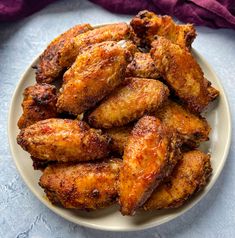 chicken wings with herbs and seasoning on a white plate