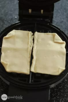 two pieces of food sitting on top of a waffle maker