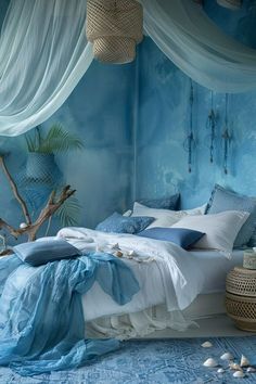 a bedroom with blue walls and white drapes on the ceiling is decorated in shades of blue