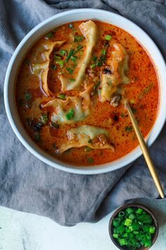 a white bowl filled with pasta and sauce