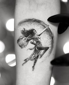 a black and white photo of a woman dancing in the rain under a glass ball