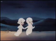 two white dogs standing next to each other in front of a night sky with mountains