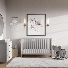 a baby's room with an elephant, zebra and crib