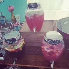 three jars filled with liquid sitting on top of a table