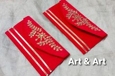 two red napkins with gold embellishments on each one and the other