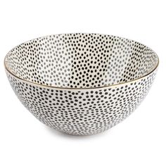 a white bowl with black dots on it