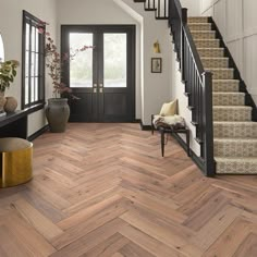 a foyer with wood floors and white walls