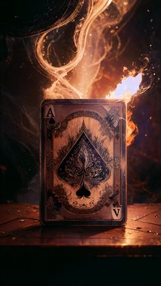 a burning ace playing card on a wooden table