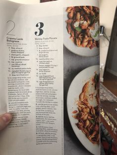 a person holding up a recipe book with food on the pages and in front of them