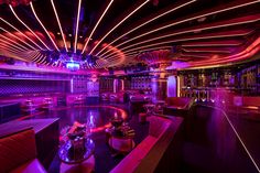 the interior of a nightclub with purple lighting