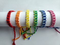 four different colored bracelets on top of each other