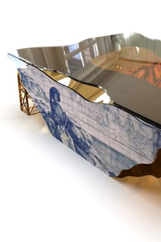 an artisticly designed coffee table with blue and white tiles