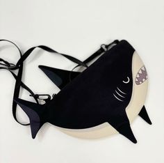 Adorable Shark Crossbody Bag - Perfect for Little Ocean Explorers Dive into the fun with this adorable shark crossbody bag! Made from high-quality canvas, this versatile bag functions as a small shoulder bag or messenger bag, making it perfect for people who love marine life. Its playful shark design adds a touch of excitement to everyday adventures. 🌊 Unique Shark Design: This cute shark bag features a detailed and playful design, ideal for any shark enthusiast. 🌊 Durable Canvas Material: Cra Adorable Shark, Shark Bag, Shark Design, Pouch Purse, Cute Shark, Cute Wallets, Everyday Adventures, Bag Canvas, Storage Pouch