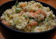 a black bowl filled with coleslaw and carrots