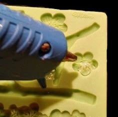 a close up of a plastic object with water droplets on the bottom and an animal in the middle