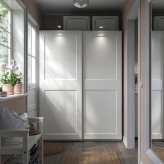 an empty hallway leading to a bedroom with white closet doors and drawers on the wall