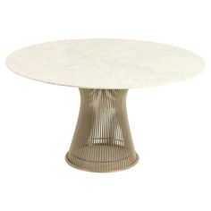 an oval table with white marble top and wicker base, viewed from the front