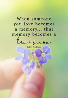 someone holding a small purple flower in their hand with the quote when someone you love becomes a memory, that memory becomes a pleasure