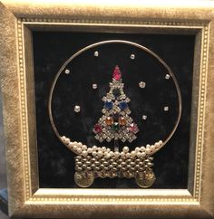 a christmas tree made out of beads in a frame