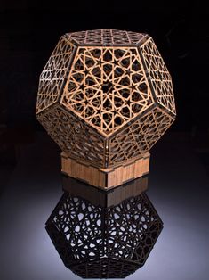 an intricate wooden object is shown in the dark