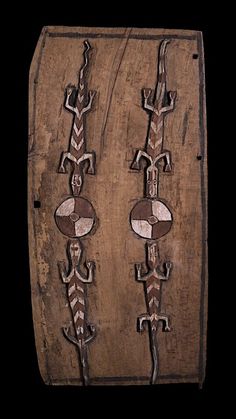 an old wooden box with two decorative carvings on it's front and back sides