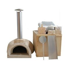 a pizza oven sitting on top of a wooden box next to a spatula and towel dispenser