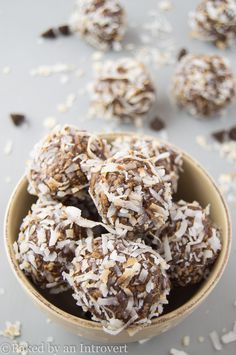 a bowl filled with chocolate coconut balls