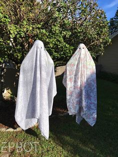 two white towels hanging on clothes line in yard