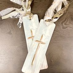 two wooden crosses are sitting on a table