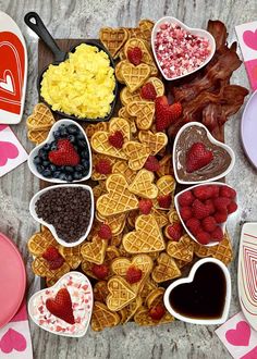 heart shaped waffles, strawberries, raspberries, chocolate hearts and other treats