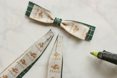 three pieces of ribbon with animals on them and one piece has a crayon pencil