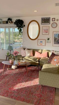 a living room filled with lots of furniture next to a large window covered in pictures