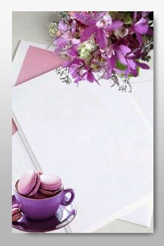 a cup of coffee and some cookies on a saucer with purple flowers in the background