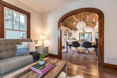 a living room filled with furniture and a wooden table