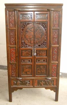 an old wooden cabinet with carvings on the doors