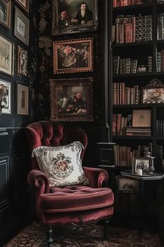 a red chair sitting in front of a book shelf filled with books