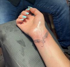 a woman's arm with a small tattoo on the left side of her wrist