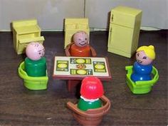 several toy people sitting around a small table