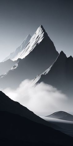 black and white photograph of mountains in the fog