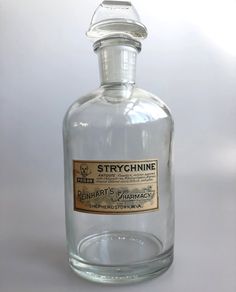 a bottle of strychnine is shown on a white surface with no one around it