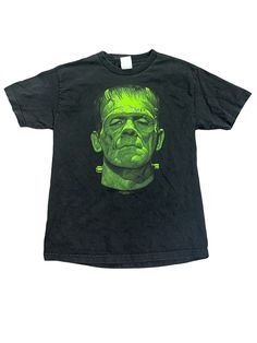 In excellent condition. There is a bleach mark on the back. I would just dye it black. Made in Mexico  Tag size large  Measurements laying flat  20" pit to pit  30" length Black Shirt Aesthetic, Frankenstein Shirt, Vintage Horror Shirt, Horror Movie Graphic Tees, Horror Movie Shirts Graphic Tees, Cheap Black Horror T-shirt, Sick Clothes, Movie T Shirts, Vintage Tees