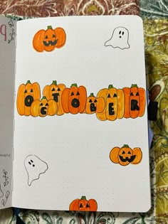 an open notebook with pumpkins and ghost faces drawn on it, next to a halloween themed page