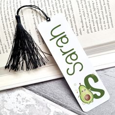 a bookmark with an avocado and tassel hanging from it